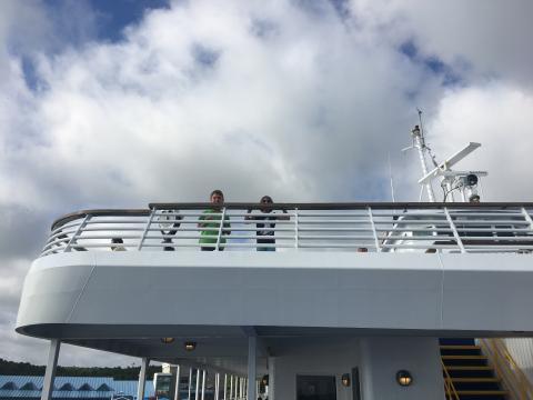 Two young children look over a railing on the Cape May - Lewes Ferry