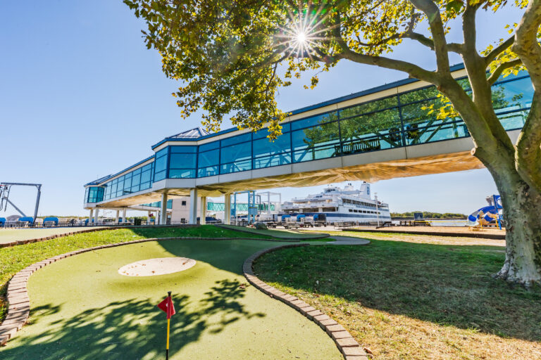 The Exterior front of the Cape May Ferry Terminal with the skywalk and Ferry in the background