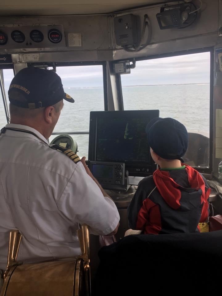 A photo of Captain Vance training a young wound-be sailor on the Bridge of the Cape May - Lewes Ferry