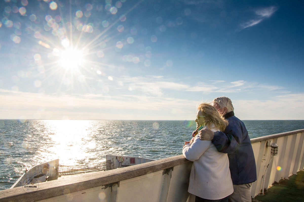 Couple looking out over the sunny view during the winter season