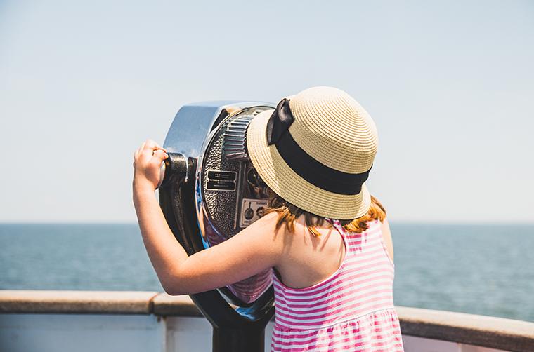 A young girl looks through a view finder on the Cape May - Lewes Ferry Deck