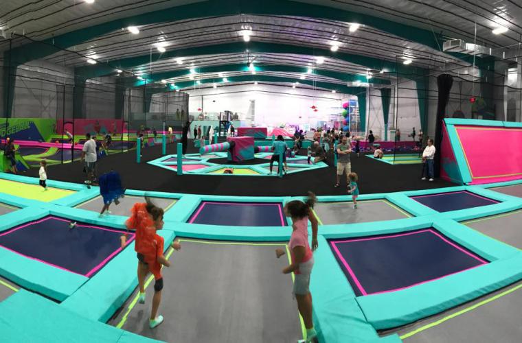 Kids jumping around on the trampoline course