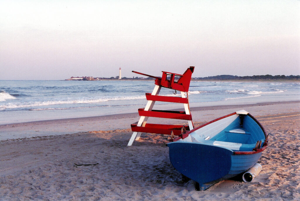 An image of the Cape May beach featuring a Cape May Lifeboat and lifeguard stand on the beach