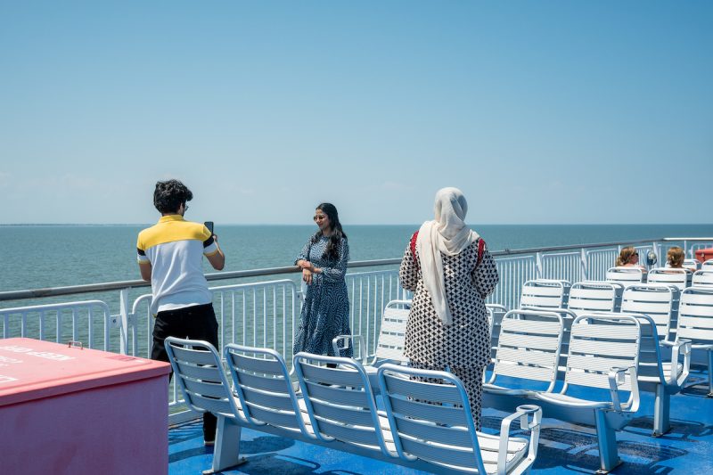 Passengers onboard the Cape May - Lewes Ferry MV Delaware as she crosses Delaware Bay with vehicles and passengers.