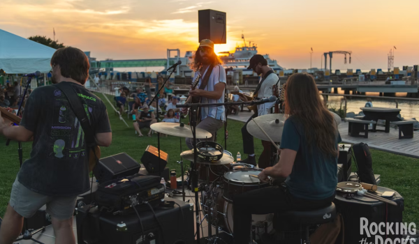 A view from behind the live band while playing at sunset during Grain's "Rocking the Docks Music Series" in 2025